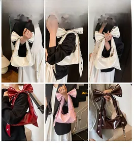 Detailed view of studded faux leather shoulder bags with bow handles in multiple colors