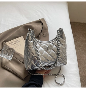 Detail of silver metallic hobo bag with quilted rhombus pattern and chain strap
