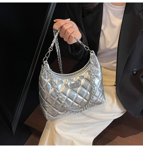 Close-up of silver quilted hobo bag with metallic finish and chunky chain strap