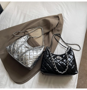 Close-up of quilted chain bags in silver mirror and glossy black finish with turn-lock