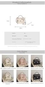 Detailed view of quilted mini box handbag with chain strap and pearl charm details