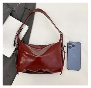 Deep red patent leather tote size comparison with a smartphone and fashion magazine