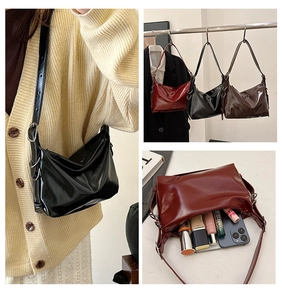 Detail view of crescent pleated tote bag in shiny leather with interior capacity display