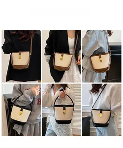 Detail of color-block bucket bags with woven texture and leather straps on models