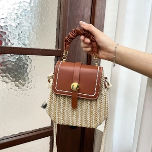 French woven leather crossbody bag with brown pleated handle and woven fiber texture