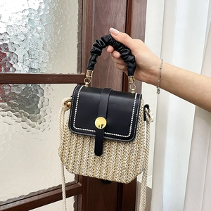French straw woven shoulder bag with black leather flap and gold metal buckle detail