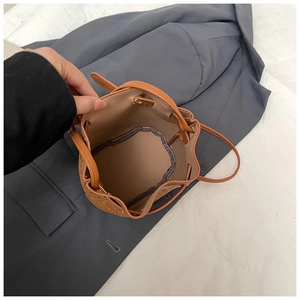 Top view of brown bucket bag interior showing spacious light lining and drawstring closure