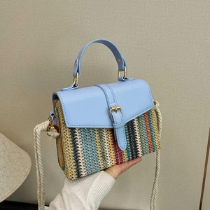 Handheld colorful woven straw shoulder bag with blue leather accents and rope strap
