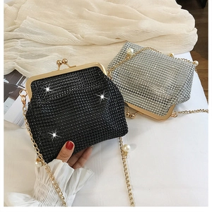 Detailed shot of glittering rhinestone evening clutches with pearl accent metal chains