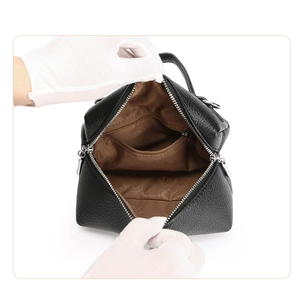 Detail showing high-quality black litchi leather exterior and brown fabric interior lining