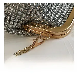 Detailed close-up of the golden lobster clasp and sparkling rhinestones on the evening bag