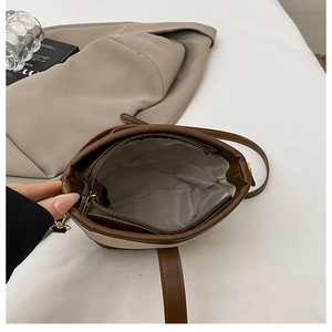 Top view of bucket bag interior showing gray herringbone lining and zipper pocket