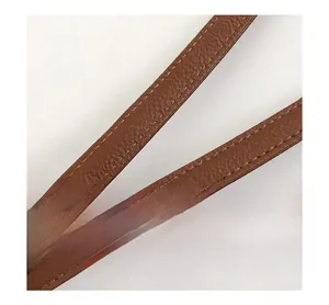 Close-up of brown litchi grain leather strap with contrast white stitching detail
