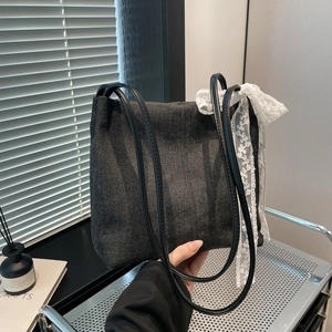 Chic washed black denim tote bag with white lace ribbon bow for 2025 fashion commute