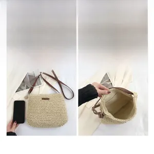 Detail of hand-woven straw bag interior featuring large capacity and small side pocket