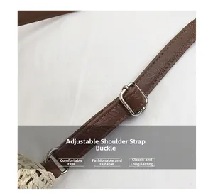 Close-up of brown litchi leather strap with adjustable silver metal buckle on woven bag