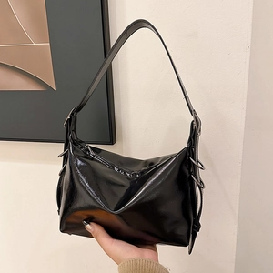 Minimalist black glossy leather tote bag with silver ring hardware for stylish commuting