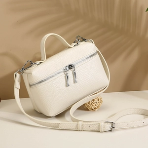 Chic off-white leather mini handbag with silver hardware and adjustable shoulder strap