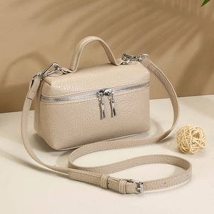 Chic beige lychee leather crossbody bag with top handle and silver zipper detail