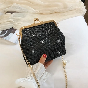 Elegant black rhinestone evening clutch bag with pearl chain strap on white background