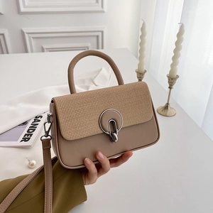 Minimalist beige and camel leather crossbody bag with silver ring buckle and woven texture