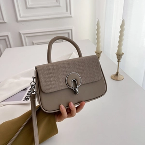 Minimalist khaki shoulder bag with woven texture flap and round silver buckle detail