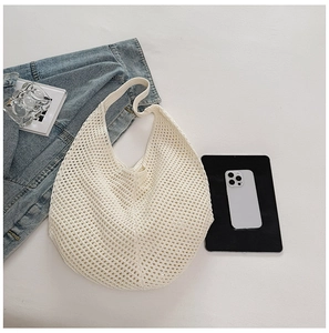 Close-up of white crochet hobo bag showing woven mesh texture and hollow-out craft
