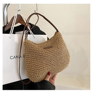 Handmade woven straw shoulder bag with dark brown leather strap for summer casual styling