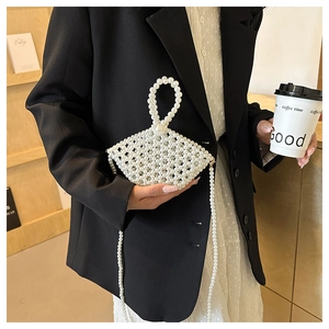 Close-up of white pearl woven handbag with geometric structure and beaded shoulder strap