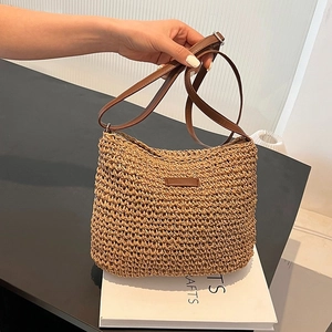Chic hand-woven straw shoulder bag with dark brown leather straps and patch for summer beach wear