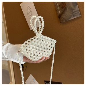 Close-up of handmade faux pearl handbag with intricate beaded weave and pearl chain strap