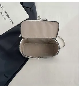 Detail view of the sleek interior layout and zigzag patterned lining of the square bag