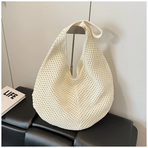 Minimalist white crochet hobo bag with hollow weave design and wide shoulder strap for summer
