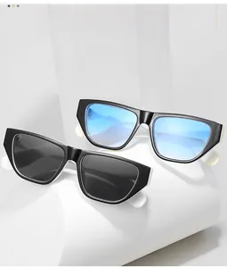 Detail of small frame sunglasses in glossy black and blue gradient with thick white temples