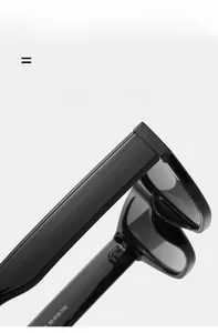 Detail view of glossy black sunglasses showing inner temple specifications and texture