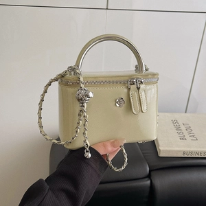 Pale yellow patent leather vanity bag with silver camellia and chain strap