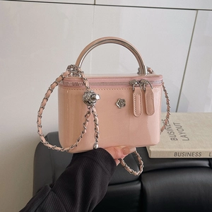 Pink patent leather mini box bag with silver metal handle and floral clasp closure