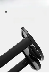 Detail view of glossy black oversized sunglasses frame showing lightweight elastic material