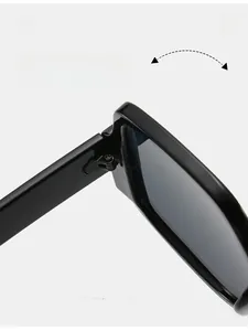 Detailed close-up of durable metal hinge on stylish black oversized sunglasses
