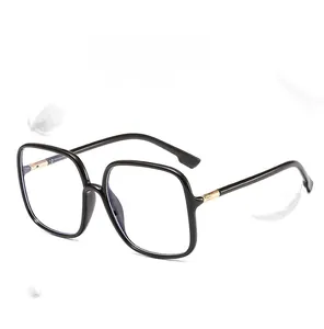 Detail of lightweight black square frame glasses with gold metal accents and feathers