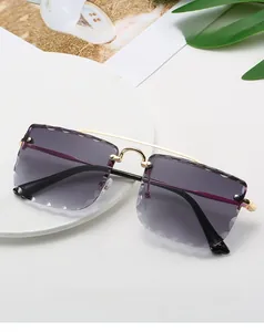 Detail of rimless square sunglasses with purple gradient lenses and wavy cut edges