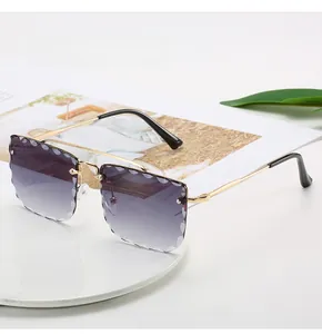 Detail of rimless sunglasses featuring scalloped wavy edges and purple gradient lenses