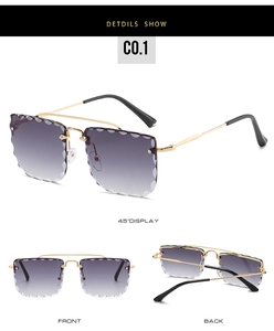 Detail view of rimless sunglasses with purple gradient lenses and scalloped wave edges