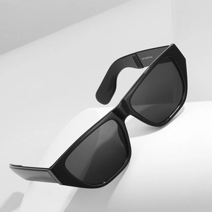 Retro geometric cat-eye sunglasses with black frames on white display blocks