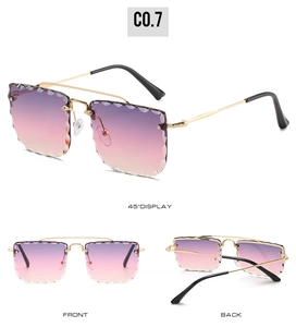 Detail of rimless sunglasses with wavy purple gradient lenses and gold metal temples