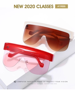 Detail of oversized shield sunglasses with thick frames and gradient tinted lenses