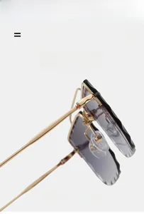Detailed close-up of flexible gold metal temples and gradient purple rimless sunglass lens