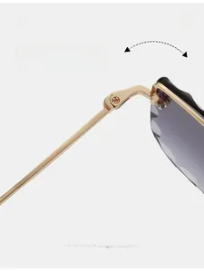 Detail of durable gold metal hinge and wave-cut edge on rimless square sunglasses