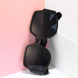 Fashionable oversized irregular geometric sunglasses with thick black frames and dark lenses