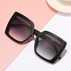 Schicke Oversize-Quadrat-Sonnenbrille mit schwarzen Rahmen und Verlaufslinsen auf Rosa